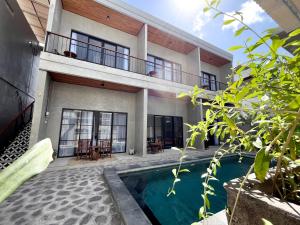 an exterior view of a house with a swimming pool at Adi surya guest house in Seminyak