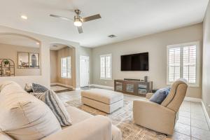 a living room with a couch and a tv at Coldwater Golf Course Getaway in Avondale! in Avondale
