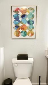 a bathroom with a painting above a toilet at Cozy Glendale Apartment in Los Angeles
