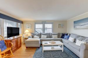 a living room with a couch and a tv at Pet-Friendly Long Beach Island Home Walk to Beach in Long Beach