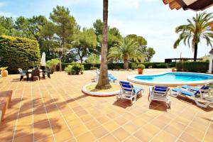 a patio with a table and chairs and a pool at Finca Coello - charming, Spanish finca style holiday villa in Benissa in Benissa +17 photos