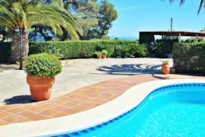 a swimming pool with a potted plant next to it at Finca Coello - charming, Spanish finca style holiday villa in Benissa in Benissa