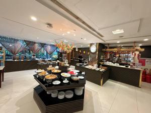 a buffet line with food on display in a restaurant at Northern Saigon Hotel in Ho Chi Minh City