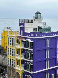a purple building with a lighthouse on top of it at 七星潭燈塔海景民宿 in Dahan
