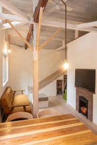 a living room with a table and a fireplace at 那須のお家komori in Nasu