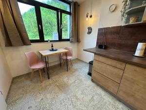 a small kitchen with a table and two chairs at Relaxen im Weindorf Mayschoß Fewo 2 in Mayschoß