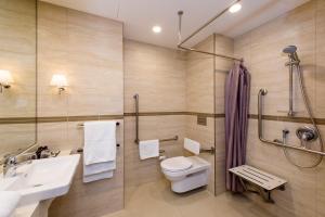 a bathroom with a toilet and a sink and a shower at SkyCity Hotel Auckland in Auckland