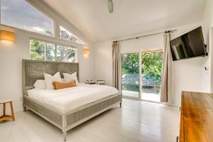 a bedroom with a bed and a large window at Luxe Oceanfront Waianae Home with Lanai - Near Beach in Waianae