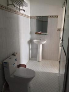 a bathroom with a toilet and a sink at Mỹ Tươi Hotel PQ - by BAY LUXURY in Phu Quoc