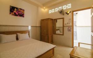 a bedroom with a large bed and a window at Mỹ Tươi Hotel PQ - by BAY LUXURY in Phu Quoc