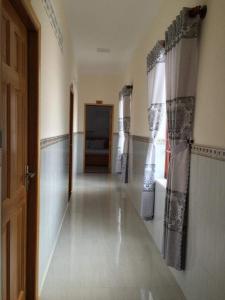 an empty hallway with a door and a window at Mỹ Tươi Hotel PQ - by BAY LUXURY in Phu Quoc