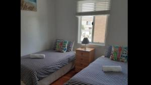 two twin beds in a room with a window at Tranquillity Manning Point in Manning Point +15 photos