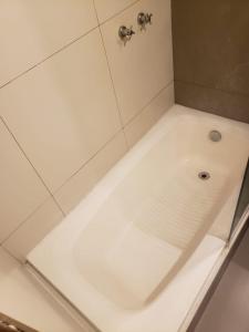 a white bath tub with a faucet in a bathroom at Rolls Hostel in Rio de Janeiro