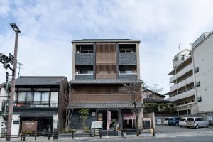 a tall building on the corner of a street at HOTEL MASTAY jingumichi in Kyoto