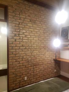 a brick wall with two lights on it at Rolls Hostel in Rio de Janeiro