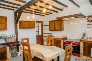 a kitchen with a wooden table in a room at MANGA BLUE'S GUEST HOUSE in Fianarantsoa