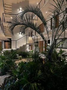 a lobby with a bunch of plants in a building at Solum Luxury Condos in Tulum