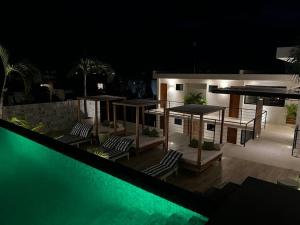 a house with a swimming pool at night at Solum Luxury Condos in Tulum
