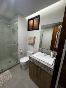 a bathroom with a sink and a toilet and a shower at Solum Luxury Condos in Tulum +11 photos