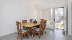 a dining room with a wooden table and chairs at Apartment 19 - The Meridian in Old Bar