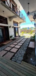 a house with a stone walkway in front of it at MAYAN SURF HOTEL in El Paredón Buena Vista