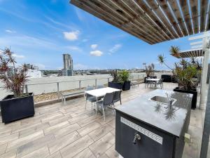 patio con tavolo e sedie sul tetto di Direct Collective - Pavilion and Governor on Brookes a Brisbane