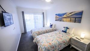 a bedroom with two beds and a window at Apartment 27 - The Meridian in Old Bar