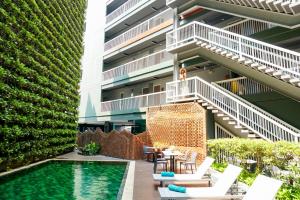 an apartment patio with a pool and a building at Cross Vibe Chiang Mai Decem, Nimman in Chiang Mai +163 photos