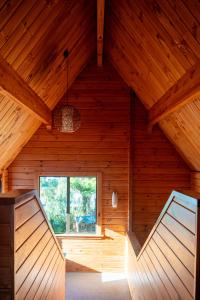 an attic of a wooden cabin with a large window at Fox Glacier Lodge in Fox Glacier