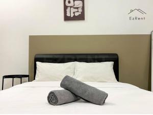 a bed with a pillow on it with at Taiping Lake Garden Peaceful Retreat near Zoo Taiping in Taiping