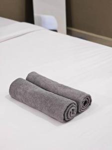 two towels sitting on top of a bed at Taiping Lake Garden Peaceful Retreat near Zoo Taiping in Taiping