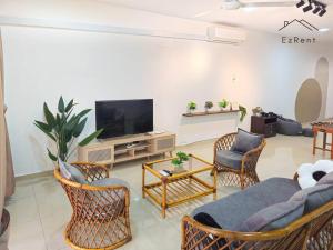 a living room with a couch and chairs and a tv at Taiping Lake Garden Peaceful Retreat near Zoo Taiping in Taiping