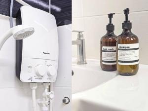 two bottles of alcohol on a counter next to a soap dispenser at Taiping Lake Garden Peaceful Retreat near Zoo Taiping in Taiping +29 photos