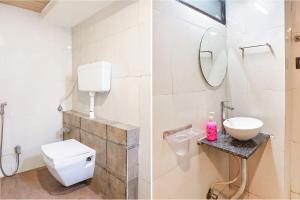 a bathroom with a toilet and a sink and a mirror at FabExpress Gargi Executive in Pune