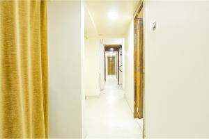 a hallway with a gold mirror and a hallway with a hallway at FabExpress Gargi Executive in Pune