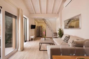 a living room with a couch and a table at Corfu Town Luxury Studio -B - New in Corfu