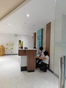 two people sitting at a counter in a room at Antara Residence Studio Condo in Talisay +9 photos