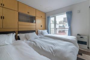 Llit o llits en una habitació de 札幌白色戀人巧克力觀光工場旁四房二衛浴包棟別墅！宮之澤地鐵站步行三分鐘 靠近超市 高速Wi-Fi