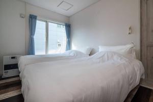 Llit o llits en una habitació de 札幌白色戀人巧克力觀光工場旁四房二衛浴包棟別墅！宮之澤地鐵站步行三分鐘 靠近超市 高速Wi-Fi
