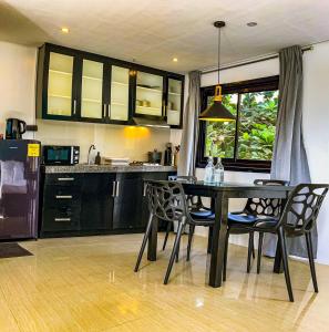 a kitchen with a dining room table and chairs at The Pacific Coast in Boracay