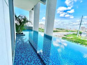 a swimming pool on the side of a building at LC 1-10Pax 3Room Cozy Home 4Qbed WiFi TV Tropicana in Petaling Jaya