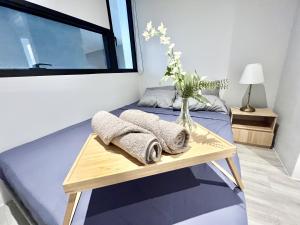 a bedroom with a bed with a vase of flowers on it at LC 1-10Pax 3Room Cozy Home 4Qbed WiFi TV Tropicana in Petaling Jaya +25 photos