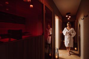 two women walking down a hallway with their arms crossed at Villa Bellevue Portoroz-Portorose in Portorož