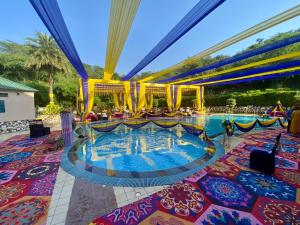 a pool at a resort with people in it at Golden Tulip Chandigarh, Panchkula in Chandīgarh