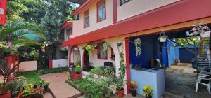 a colorful house with plants on the side of it at Gracias Villa in Panaji