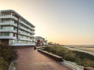 a building on the beach next to the ocean at Haas Comfortable holiday residence in Wangerooge