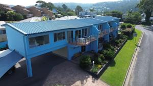 an overhead view of a house with a blue roof at BlueWater Apartments in Merimbula