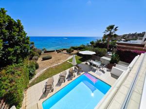 an overhead view of a swimming pool and the ocean at Villa Rosalia in Coral Bay