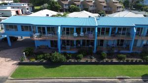 an aerial view of a blue house with a blue roof at BlueWater Apartments in Merimbula