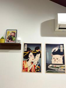 three pictures of a woman and a cat on a wall at 西九条 CHILL - Nishikujo CHILL in Osaka